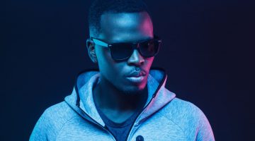 Close-up portrait of stylish black man, wearing hoodie and sunglasses